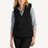 Front view of women’s navy and black waterproof puffer vest on model – Louvóre apparel